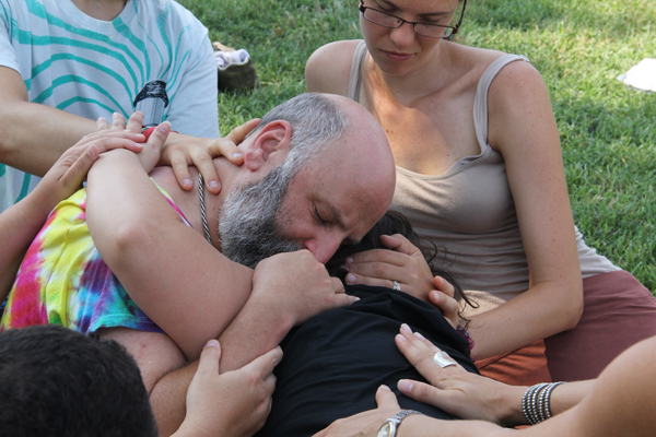 group of people folded on top of each other, sitting on grass on the Washington Mall, DC